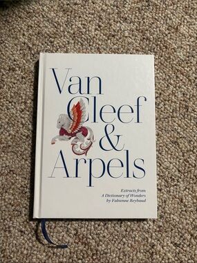 Van Cleef & Arpels White Cover Book with Blue Lettering and Red Accent
